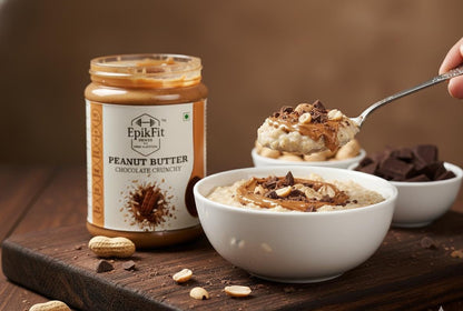 EpikFit Peanut Butter Chocolate Crunch jar with bowls of dessert and a spoon on a wooden surface.